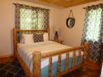 Alpine Retreat - Main bedroom with Log Queen bed.